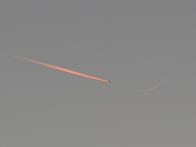 Jet Approaching a Crescent Moon