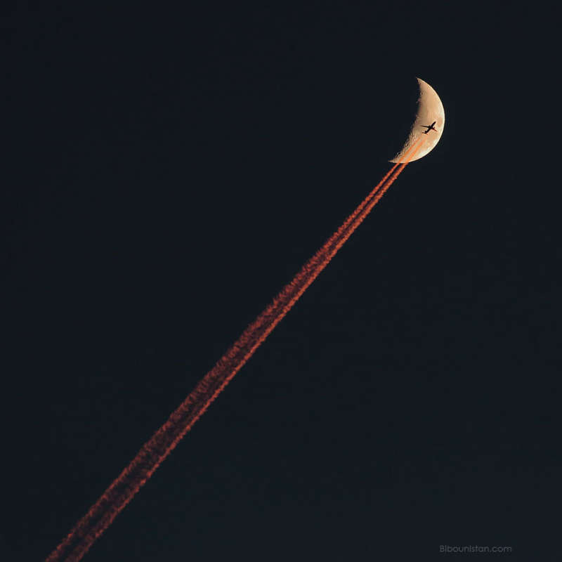 Plane Crossing a Crescent Moon