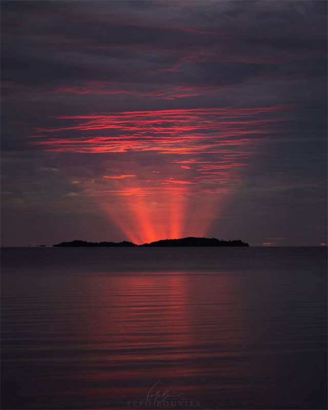 Red Crepuscular Rays from an Eclipse