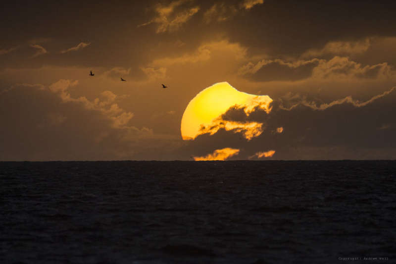 A Partially Eclipsed Setting Sun