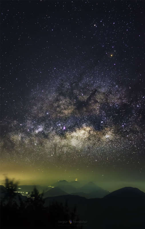 Milky Way over Erupting Volcano