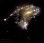 AM1054: formirovanie zvezd pri stolknovenii galaktik